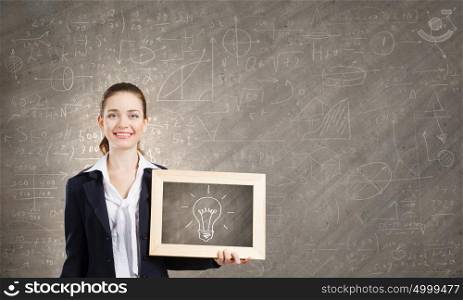 Idea concept. Young woman holding wooden frame with sketches