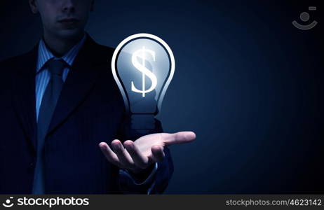 Idea for your income. Close view of businessman in suit holding dollar sign in palm
