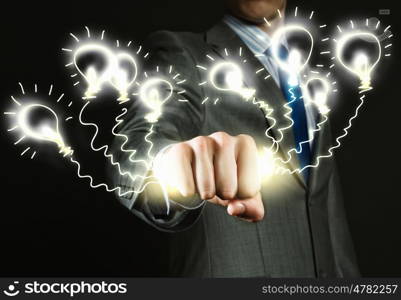 Idea generate. Close up of businessman hand holding light bulbs in fist