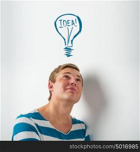 Idea man - brainstorming. Handsome young man contemplating. Graphic lamp - symbol of new idea, overhead