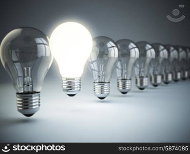 Idea or uniqueness, originality concept. Row of light bulbs with glowing one on blue background, 3d