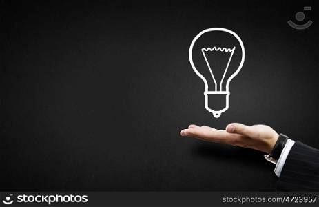 Idea presentation. Huma hand presenting light bulb concept on palm