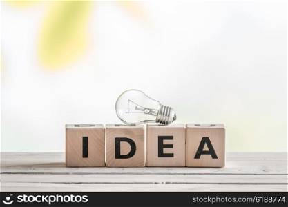Idea sign with a light bulb on a table