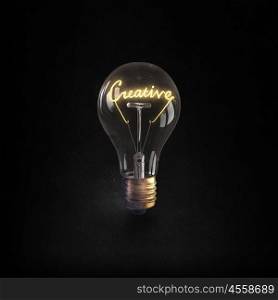 Ideas for business. Glowing glass light bulb with creative word inside