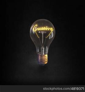Ideas for business. Glowing glass light bulb with creative word inside