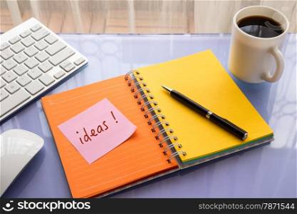 Ideas word on note pad stick on blank colorful paper notebook at office table , concept for brainstorming