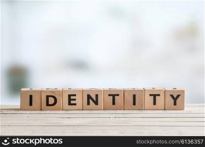 Identity sign made of cubes on wooden table