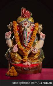 idol of lord ganesha with sweets 
