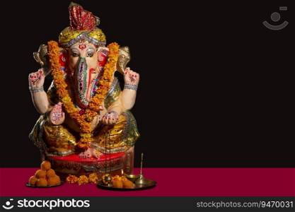 idol of lord ganesha with sweets 