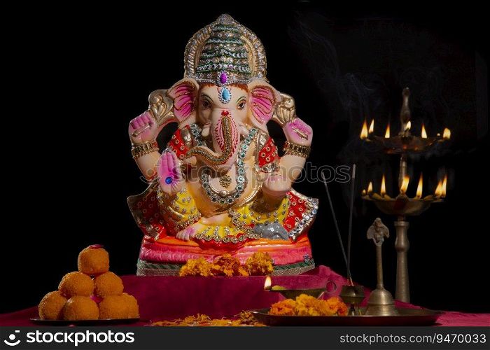 idol of lord ganesha with sweets and l&