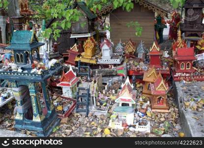 Idols and houses under the tree in Ko Samui, Thailand
