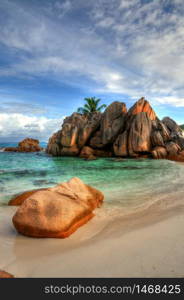 Idyllic beach with granitic rocks in Anse Cocos, La Digue island, Seychelles