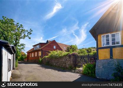 Idyllic danish street with old buildings in vintage colors under a blue sky in the summer