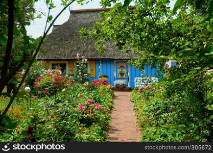 idyllic garden with blue fisherman house