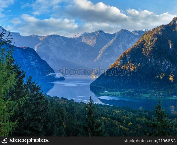 Idyllic morning colorful autumn alpine view. Peaceful mountain lake with reflections on water surface. Hallstatter lake, Upper Austria.