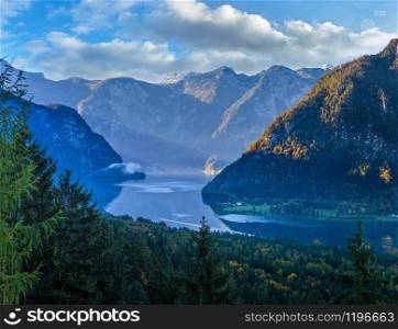 Idyllic morning colorful autumn alpine view. Peaceful mountain lake with reflections on water surface. Hallstatter lake, Upper Austria.