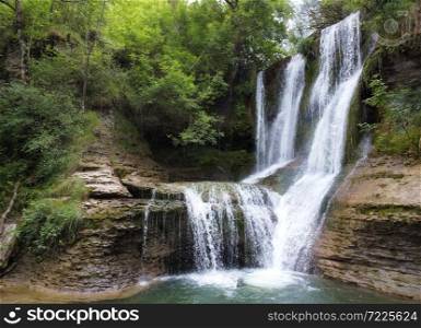 Idyllic rain forest waterfall, stream flowing in the lush green forest. High quality image.. Idyllic rain forest waterfall, stream flowing in the lush green forest.