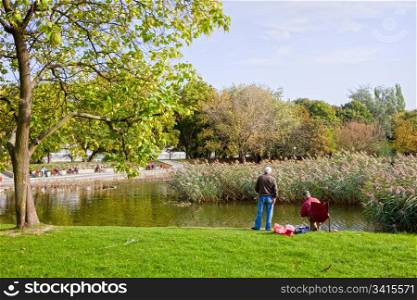 Idyllic tranquil scenery in the city park with small lake in autumn