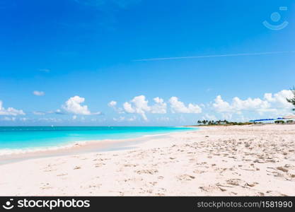 Idyllic tropical beach with white sand, turquoise ocean water and blue sky. Idyllic tropical beach in Caribbean with white sand, turquoise ocean water and blue sky