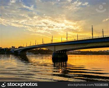 Idyllic view of Bridge over Rhine river against sunset in the city of Bonn, Germnay. Backlighting of bridge against dawn.. Idyllic view of Bridge over Rhine river against sunset in the city of Bonn, Germnay.