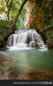 Idyllic Waterfall in rainforest landscape. Water flowing in tranquil scenery .. Idyllic Waterfall in rainforest landscape. Water flowing in tranquil scenery.