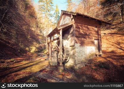 Idyllic watermill in Austria, autumn time, forest in autumn