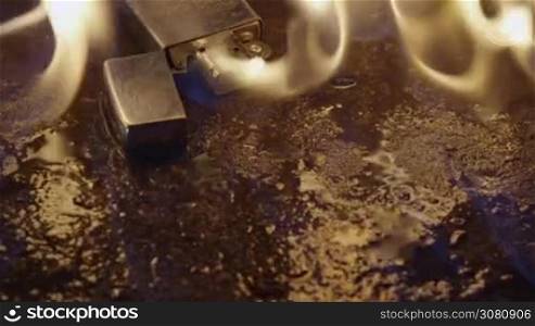 Ignition of gasoline with an electric lighter. The blue wave of fire moves to the camera.