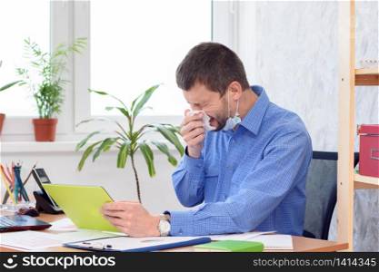Ill office worker sneezes at work place