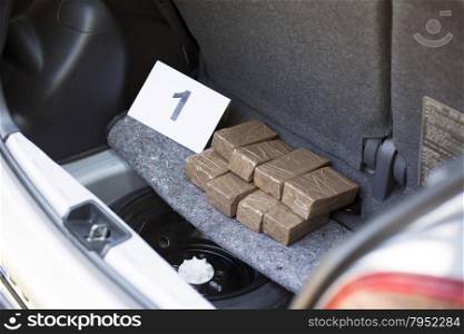 Illegal drug trade in the trunk of a car