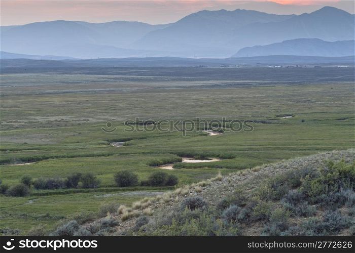 Illinois River meanders through Arapaho National Wildlife Refuge, North Park near Walden, Colorado, late summer scenery at dusk