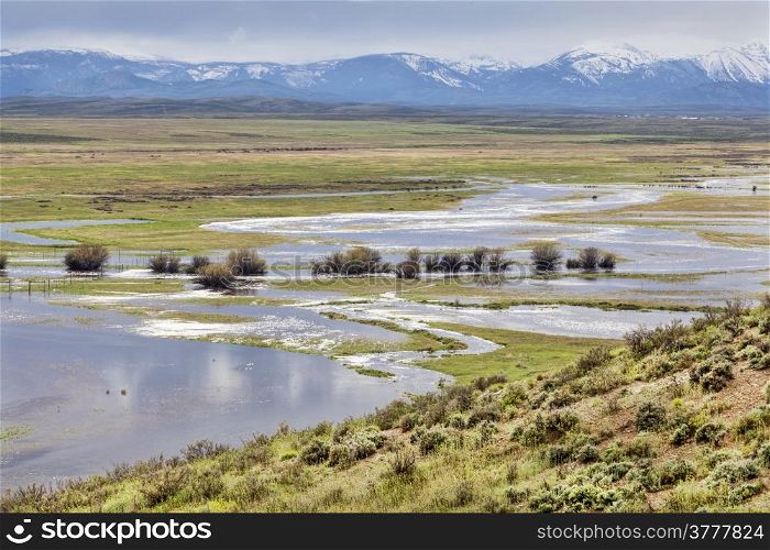 Illinois River meanders through Arapaho National Wildlife Refuge, North Park near Walden, Colorado, spring scenery with flooded meadows
