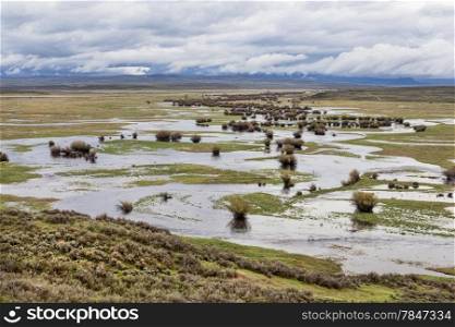 Illinois River meanders through Arapaho National Wildlife Refuge, North Park near Walden, Colorado, spring scenery with flooded meadows
