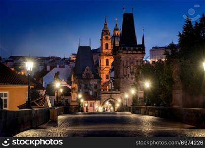Illuminated ancient towers on Charles bridge in Prague
