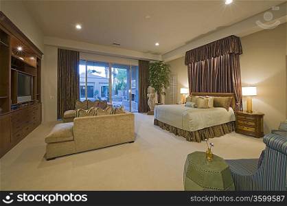 Illuminated bedroom in luxurious residence