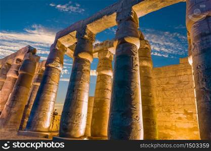 Illuminated columns in Luxor Temple at sunset, Egypt
