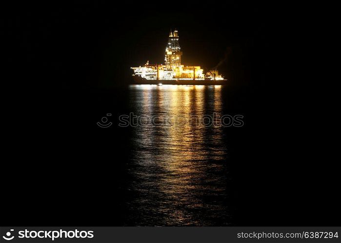 Illuminated cruise ship in ocean at night