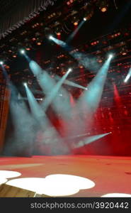 Illuminated empty concert stage with smoke