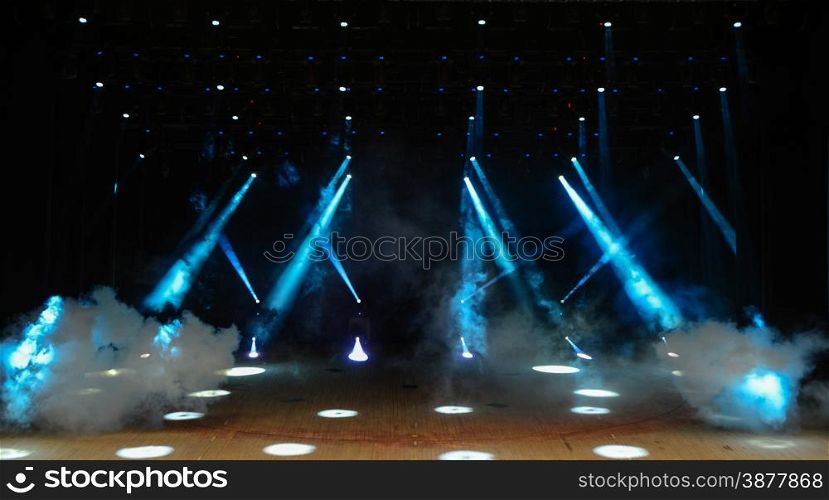 Illuminated empty theater stage with fog and rays of light