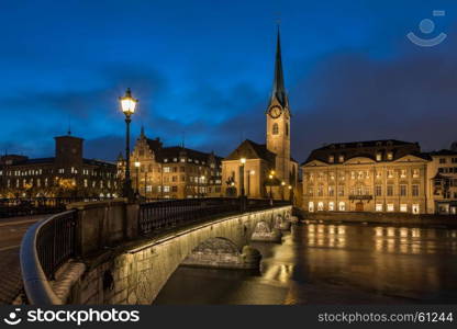 Illuminated Fraumunster Church and River Limmat in Zurich, Switzerland