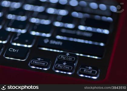 Illuminated keyboard. Focus on arrow keys. Shallow depth of field