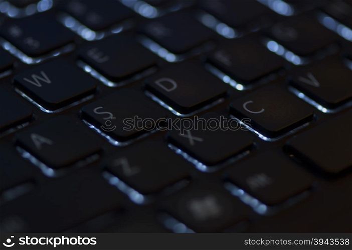 Illuminated keyboard. Focus on WASD keys