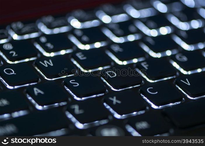 Illuminated keyboard. Focus on WASD keys. Shallow depth of field