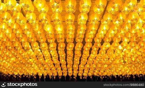 Illuminated lighting of many overhead hanging yellow Chinese lanterns decoration at night in Vegetarian Festival, Chinese language on the lantern means good fortune and good health
