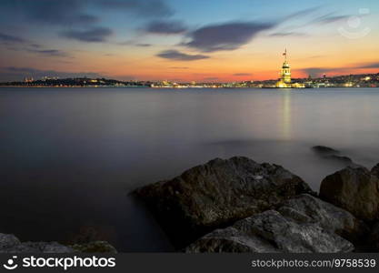 Illuminated Maiden Tower and Istanbul panorama at sunset, Turkey