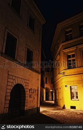 illuminated mysterious narrow alley at night in Prague