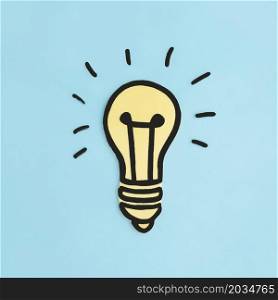 illuminated paper cutout yellow light bulb blue background