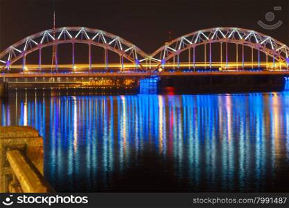 Illuminated Railway Bridge and River Daugava, Riga Radio and TV Tower at night, Latvia