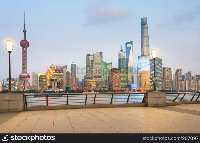Illuminated Shanghai skyline with tv tower and skyscrapers of modern architecture in the evening, China