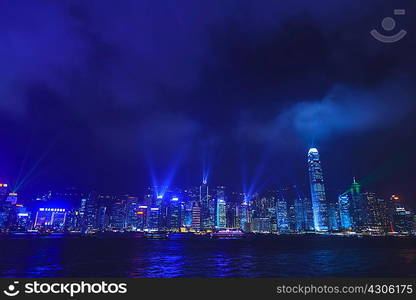 Illuminated skyscrapers along the waterfront of Hong Kong, China