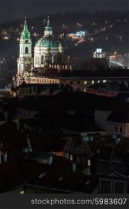 illuminated St. Nicholas church at night, Prague, Czech Republic